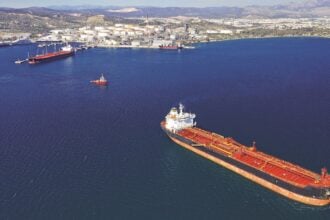 Aerial drone photo of huge crude oil and fuel tanker ship docked in industrial area of Elefsina, Attica, Greece